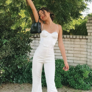 Woman in white Beginning Boutique top and pants