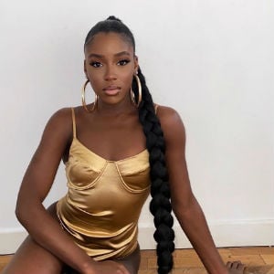 Woman in gold PrettyLittleThing dress