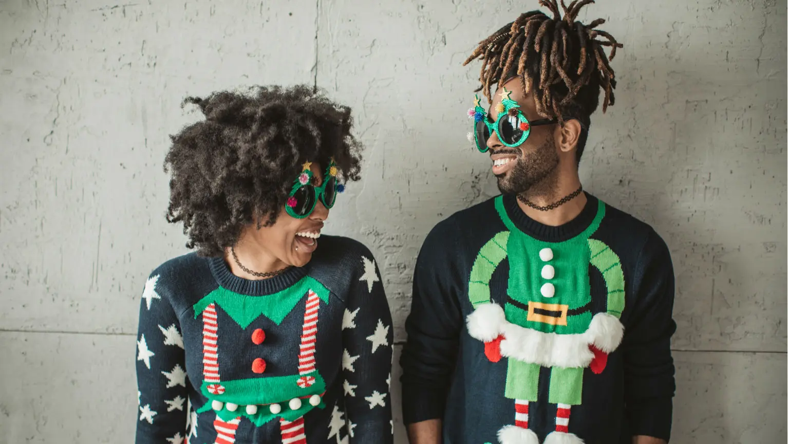 Couple in ugly Christmas sweaters