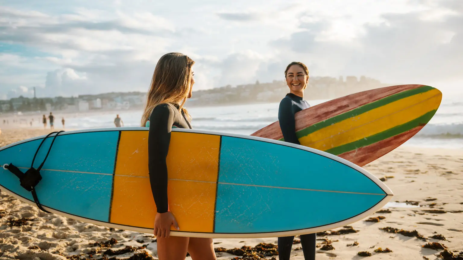 Two female friends with surfboards in Australia
