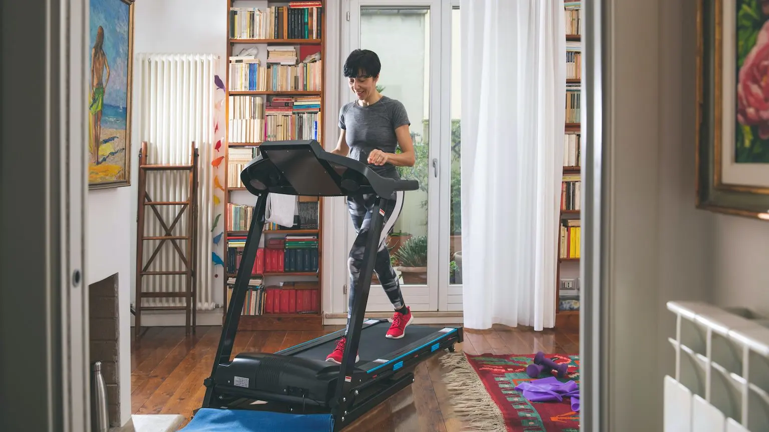 Woman running on a treadmill at home