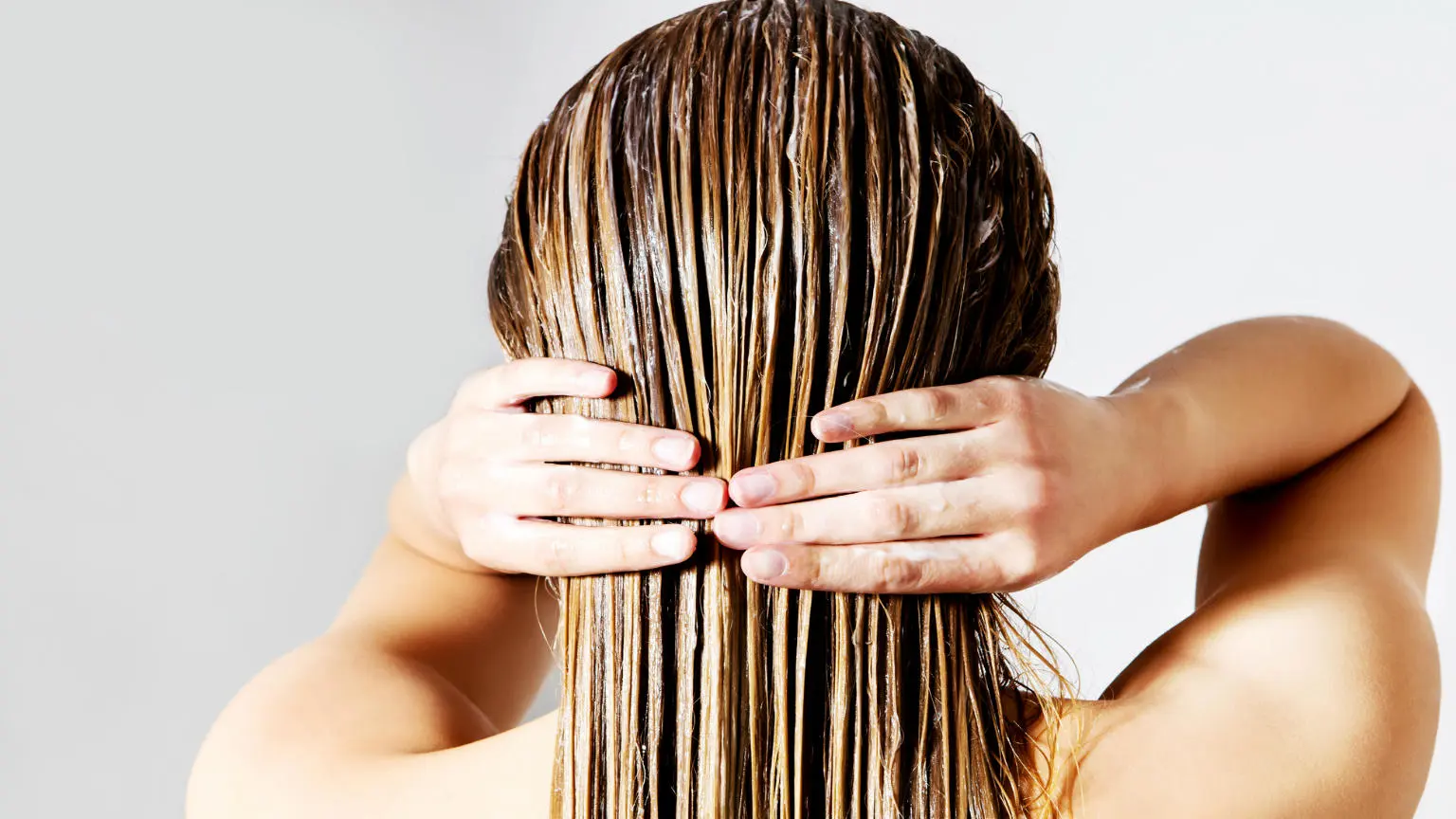 Woman applying hair conditioner