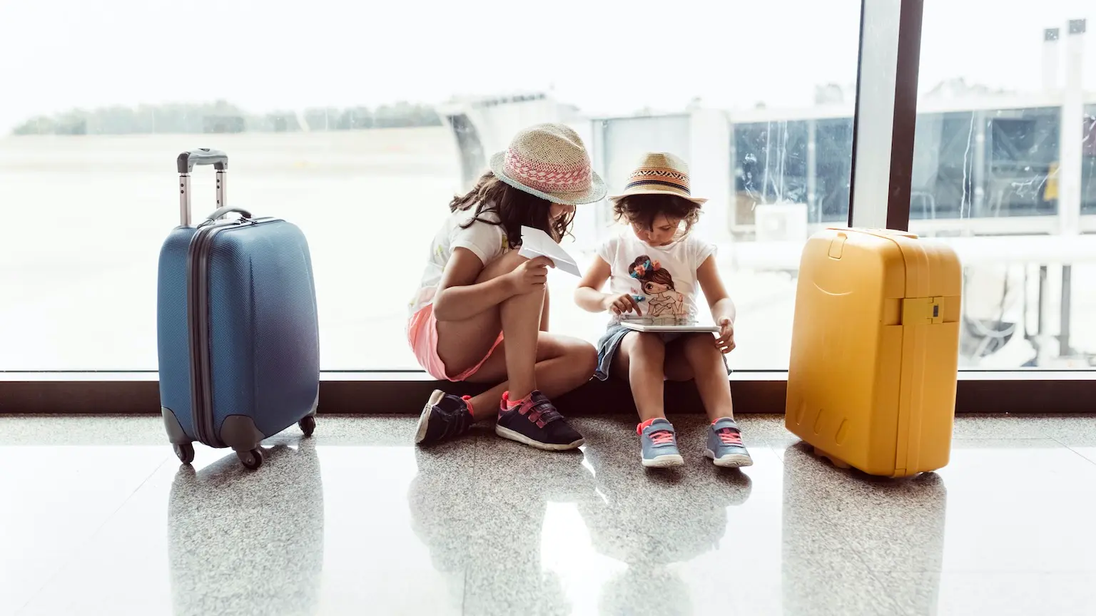 Asturias, Spain, two little girls waiting at the airport terminal