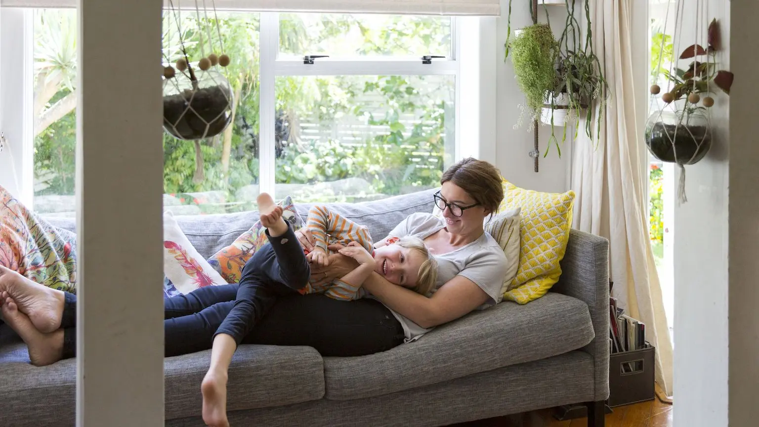 Woman and her son relaxing on the couch together