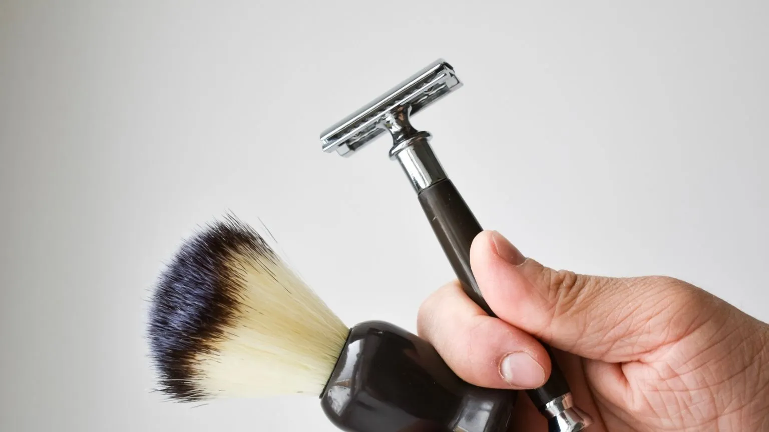 Man Holding Shaving Kit