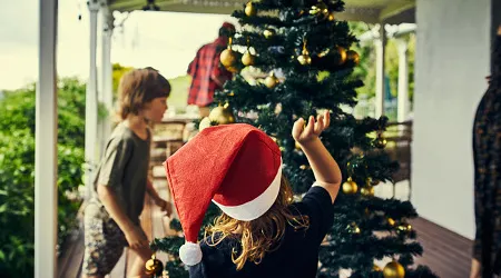 Cropped shot of kids decorating the Christmas tree
