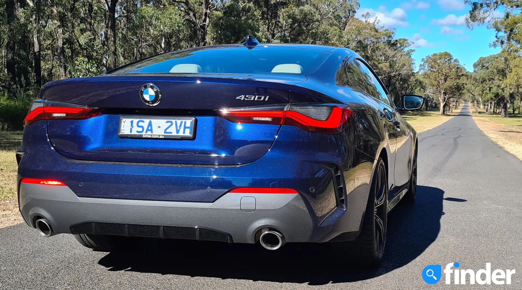 2021 BMW 430i Coupé on long, straight stretch of road.