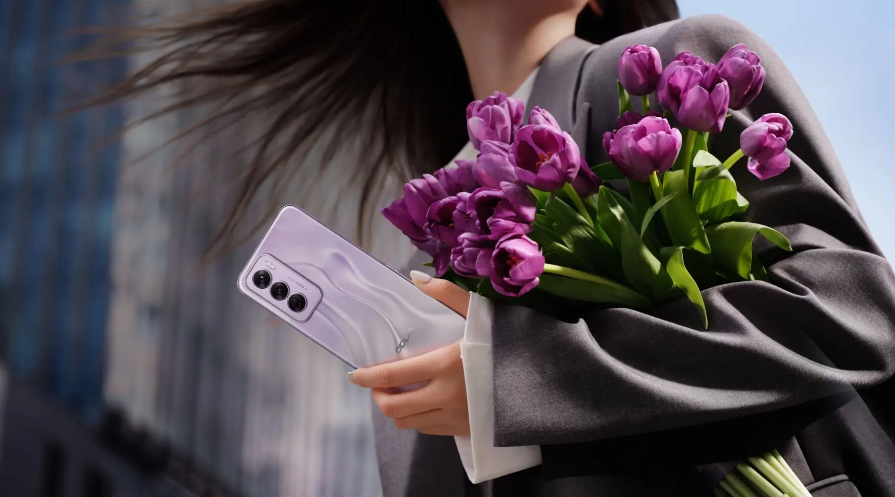 Woman with bouquet of flowers holding an Oppo phone